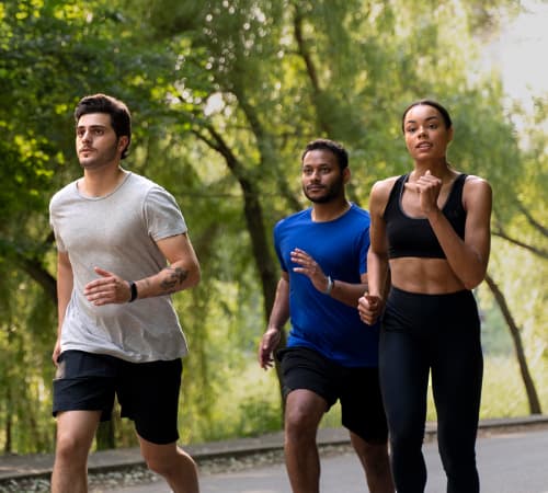 A picture of three people jogging together.